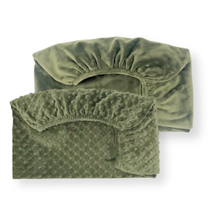 May include: Two green fitted sheets, one with a smooth texture and the other with a textured pattern of small dots.