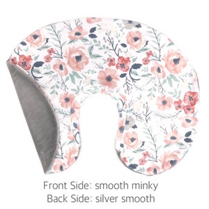 May include: A U-shaped nursing pillow with a floral print on one side and a solid gray minky fabric on the other side. The floral print features pink and white flowers on a white background.  Front Side: smooth minky Back Side: silver smooth