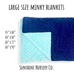 May include: A minky blanket with a textured dot pattern, featuring a dark blue side and a light blue side. Text reads: LARGE SIZE MINKY BLANKETS, 45" x 60", 60" x 60", 60" x 72", 60" x 90", and Sunshine Nursery Co.