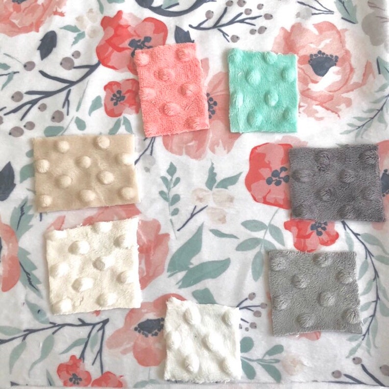 May include: A set of eight fabric squares in various colors and textures. The squares are made of a soft, plush material with raised dots. The colors include beige, white, light gray, dark gray, light pink, and light green.