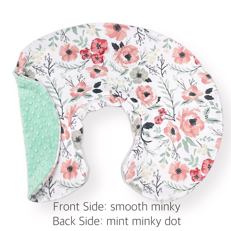May include: A U-shaped nursing pillow with a floral print on the front and a mint green minky dot fabric on the back. The text "Front Side: smooth minky Back Side: mint minky dot" is printed below the pillow.