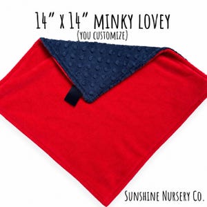 May include: A 14 inch by 14 inch minky lovey blanket featuring a smooth red side and a navy blue side with a raised dot texture. The text 14 inch x 14 inch MINKY LOVEY (YOU CUSTOMIZE) and Sunshine Nursery Co. is printed on the image.