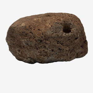 May include: A rough, brown rock with a porous texture and a hole on one side. The rock is a natural, earthy tone, and the surface is uneven with small holes and indentations. The overall shape is rounded and irregular.