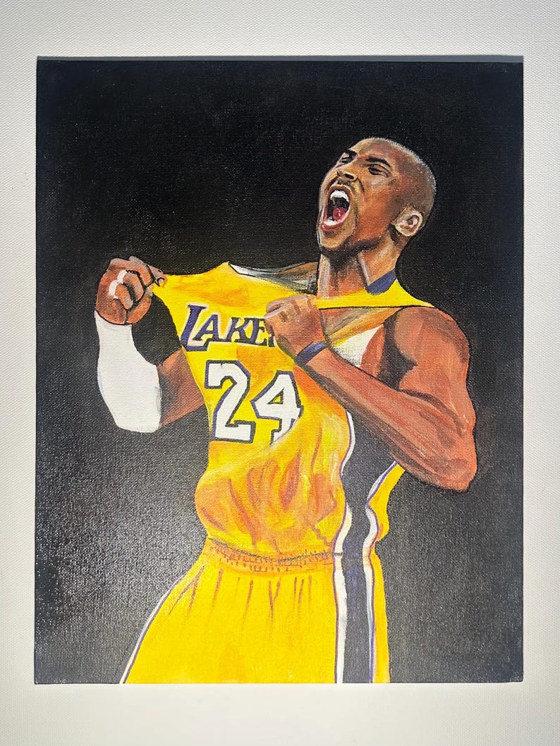 May include: A painting depicting a basketball player in a yellow and purple jersey, number 24. The player is pulling at the jersey, with an open mouth and a determined expression. The background is black.