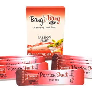 May include: A box of 10 single-serving packets of Bang Energy drink mix in Passion Fruit flavor. Each packet contains 3 calories and is labeled "Drink Mix". The box is red and white and features the Bang Energy logo.
