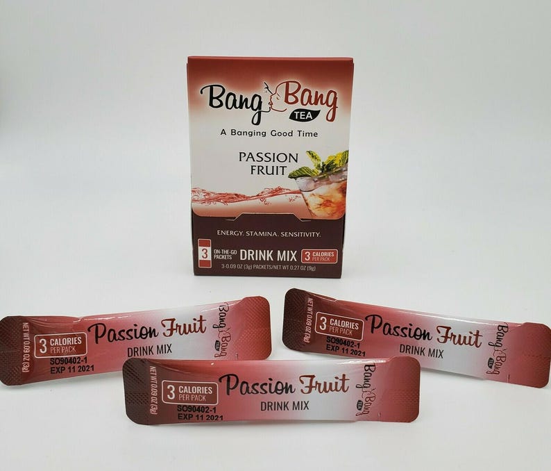 May include: Three individual packets of Bang Bang Tea Passion Fruit Drink Mix. Each packet is red and white with the Bang Bang logo and text that reads "Passion Fruit Drink Mix" and "3 Calories Per Pack".