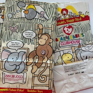 May include: Several vintage McDonald's Happy Meal bags featuring cartoon illustrations of animals and the text "teenie BEANIE BABIES CLUBHOUSE". The bags have a red and white color scheme and include the Fisher-Price Toddler Toys logo.