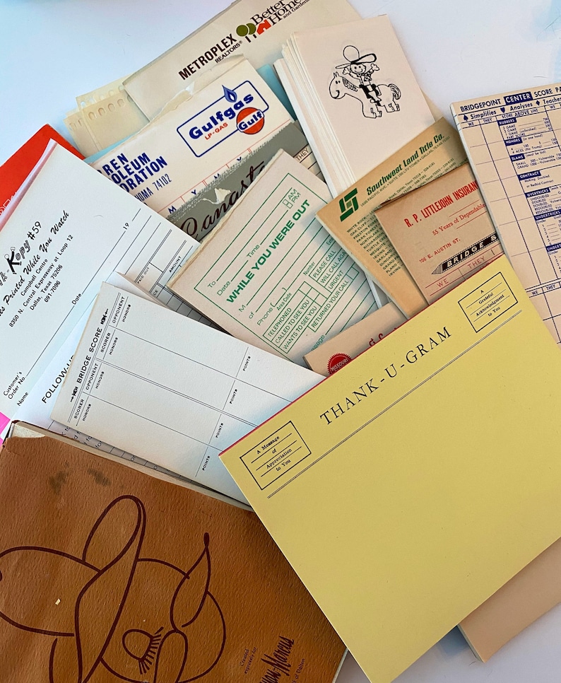 May include: A collection of vintage paper documents and stationery, including a yellow thank you note pad, a bridge scorecard, a Gulfgas LP-Gas receipt, and a Southwest Land Title Co. document. The documents are scattered on a white surface.