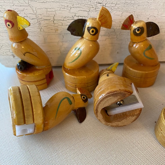 A hand-carved wooden bird that moonlights as a pencil sharpener — novelty desk art with actual function, in tropical parrot/toucan form.
