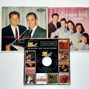 May include: A black and white record with a picture of Lawrence Welk and the Lennon Sisters. The record is titled "My Grandfather's Clock" and is from the Dot Records label. The record is surrounded by other records from the Dot Records label.