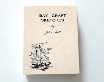 May include: A rectangular book with a textured cream-colored cover featuring the black printed text BAY CRAFT SKETCHES by John Moll and a black ink illustration of a sailboat on the water positioned in the lower left corner of the front cover.