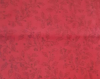 May include: A deep red fabric featuring a repeating tonal pattern of dark red holly leaves and berries. The design consists of delicate, thin-lined botanical illustrations spread evenly across the entire surface of the solid red textile material.