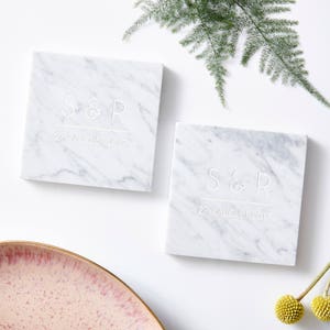 May include: Two white marble coasters with the initials "S&R" and the date "22nd August 2017" engraved in white.