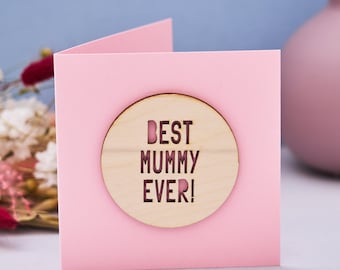 May include: Pink card with a wooden circle that says "Best Mummy Ever!" in black letters.