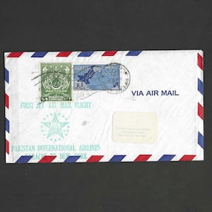 May include: A white ceramic mug with a black handle and the text "But First, Coffee" in a black, bold font. The mug is on a white surface. The mug is approximately 10 cm tall.