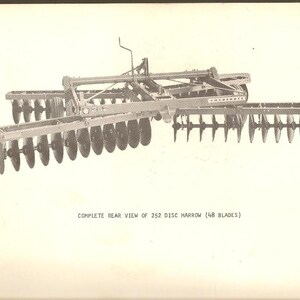 May include: A rear view of a 252 disc harrow with 48 blades. The harrow is made by Cockshutt.