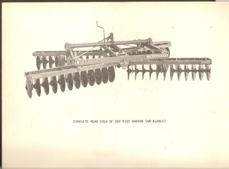 May include: A rear view of a 252 disc harrow with 48 blades. The harrow is made by Cockshutt.