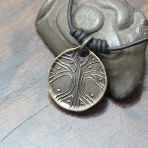 Norse Viking Yggdrasil Tree Iron Coin Pendant on a leather necklace.