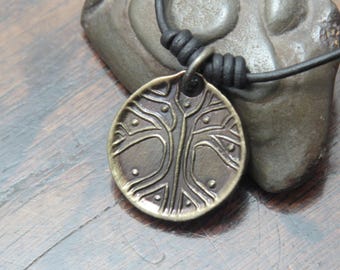 Norse Viking Yggdrasil Tree Iron Coin Pendant on a leather necklace.