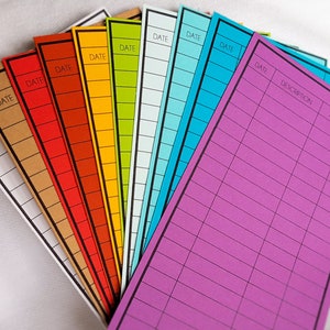 May include: A set of ten colorful lined index cards with black borders. Each card has the word "DATE" printed at the top. One card has additional headings: "DESCRIPTION", "AMT", and "BAL".