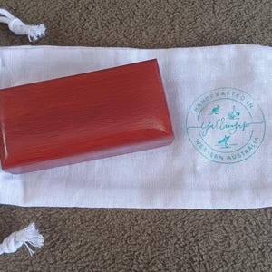 May include: A rectangular reddish-brown wooden box with a smooth finish resting on a white fabric drawstring pouch. The pouch features a circular teal logo with the text Handcrafted in Western Australia and Yallingup with small icons.