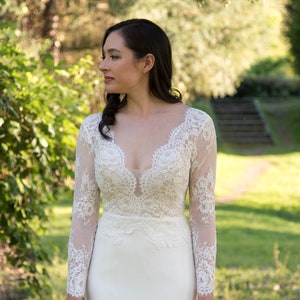 Long sleeve lace wedding dress alencon lace top with crepe skirt fit and flare