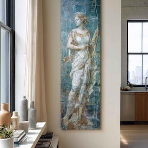 May include: A tall, rectangular wall art piece featuring a classical figure in a white, draped garment holding a bow and arrows. The artwork has a distressed, weathered appearance with a blue-green background and visible grid-like tile patterns.