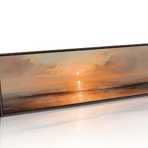 May include: A panoramic landscape painting in a dark brown frame depicting a sunset over the ocean. The scene features a bright sun low on the horizon, casting warm orange and golden light across the clouds and the calm, reflective water surface.