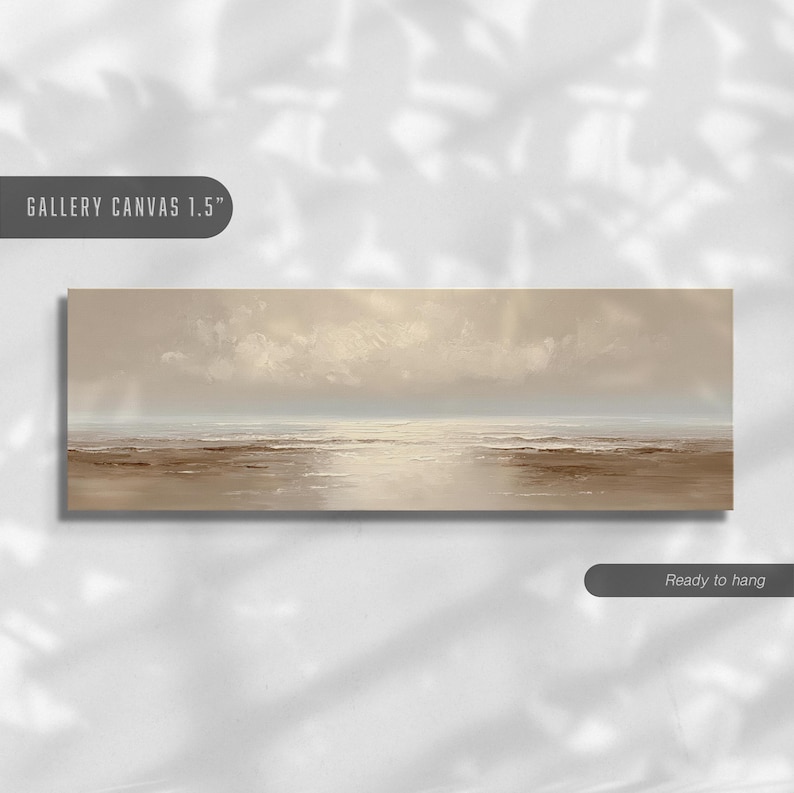 May include: A rectangular canvas print depicting a serene seascape. The artwork features a muted color palette of beige, brown, and white, with a cloudy sky and calm water. The text "GALLERY CANVAS 1.5" and "Ready to hang" are visible.