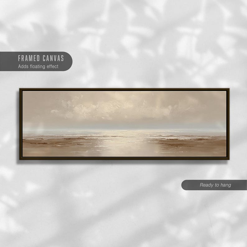 May include: A framed canvas art piece depicting a serene seascape. The artwork features a muted color palette of beige, brown, and white, with a dark brown frame. The text "FRAMED CANVAS Adds floating effect" is visible.