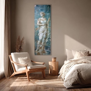 May include: A vertical rectangular wall art print featuring a classical figure in a flowing white draped garment holding a bow. The artwork has a distressed blue and gold textured background with visible cracks and weathered paint effects.