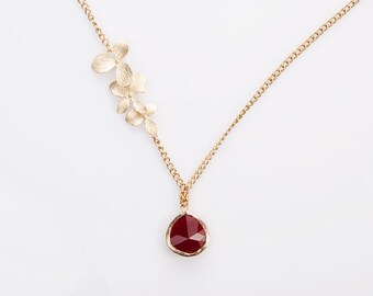 Necklace: Gold plated frame, faceted  ruby glass pendant tripple gold plated leaves