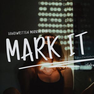 May include: White handwritten marker font with the text "MARK IT" in large letters. The font is designed by Yuliya Derbisheva and includes extras. The image has a dark background with a person in the center.