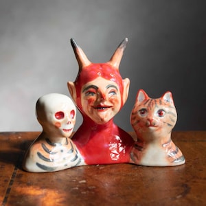 Retro Halloween ceramic ornament of a red Devil with a skeleton and tabby cat. British made by artist Kayleigh Radcliffe
