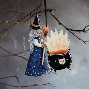 Wooden witch with a cauldron hanging ornament. Halloween decoration, vintage style