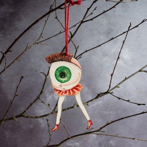 Eyeball man Halloween hanging ornament, made from laser cut wood. Made in the UK