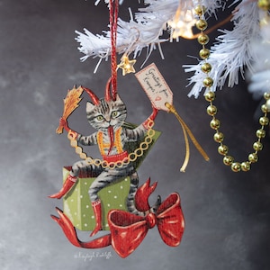 Krampus tabby cat Christmas wooden hanging ornament. Double sided. Designed and illustrated by Kayleigh Radcliffe