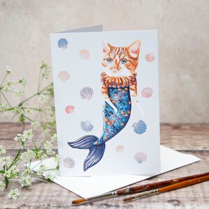 A6 greeting card made in the UK. Louie the cat fish. Cat mermaid, cat illustration, cat art, card for a cat lady, card for any occasion.