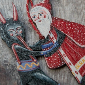 Wooden hanging Christmas ornament featuring Saint Nick dancing with the Christmas Krampus image 6