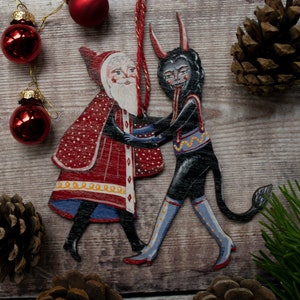 Wooden hanging Christmas ornament featuring Saint Nick dancing with the Christmas Krampus image 2
