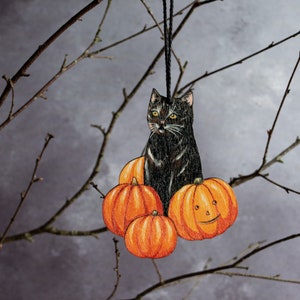 Black cat in a pumpkin patch Halloween hanging ornament. Vintage style decor made from wood