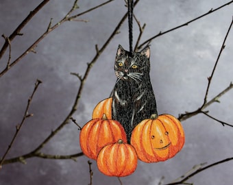 Black cat in a pumpkin patch Halloween hanging ornament. Vintage style decor made from wood