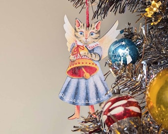 May include: A wooden Christmas ornament shaped like a cat angel holding a bell. The cat is wearing a blue dress with a red collar and white wings. The ornament is hanging on a silver tinsel Christmas tree.