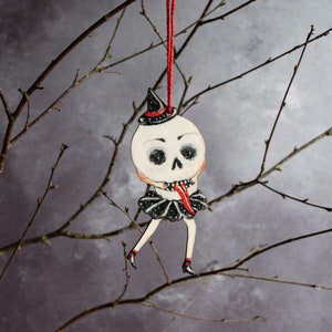 Skull pulling tongues Halloween hanging decoration, made from laser cut wood. Made in in the UK