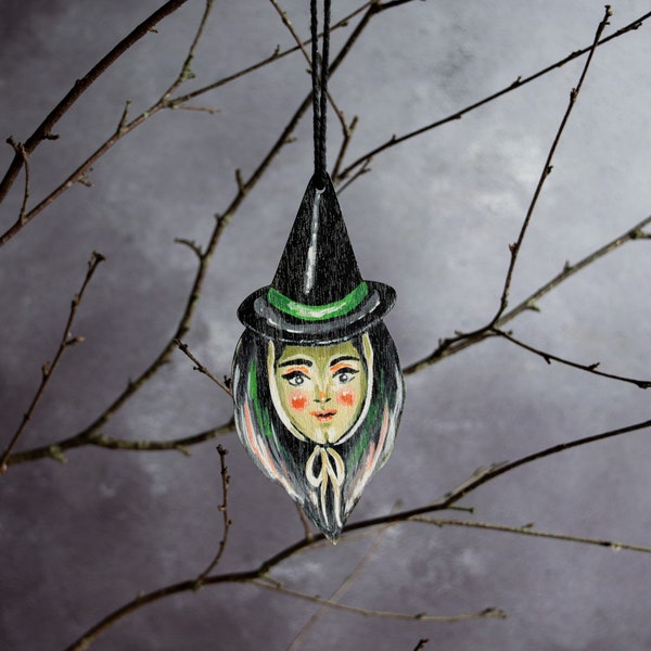 Vintage style witch head hanging ornament made from wood. Retro Halloween decor