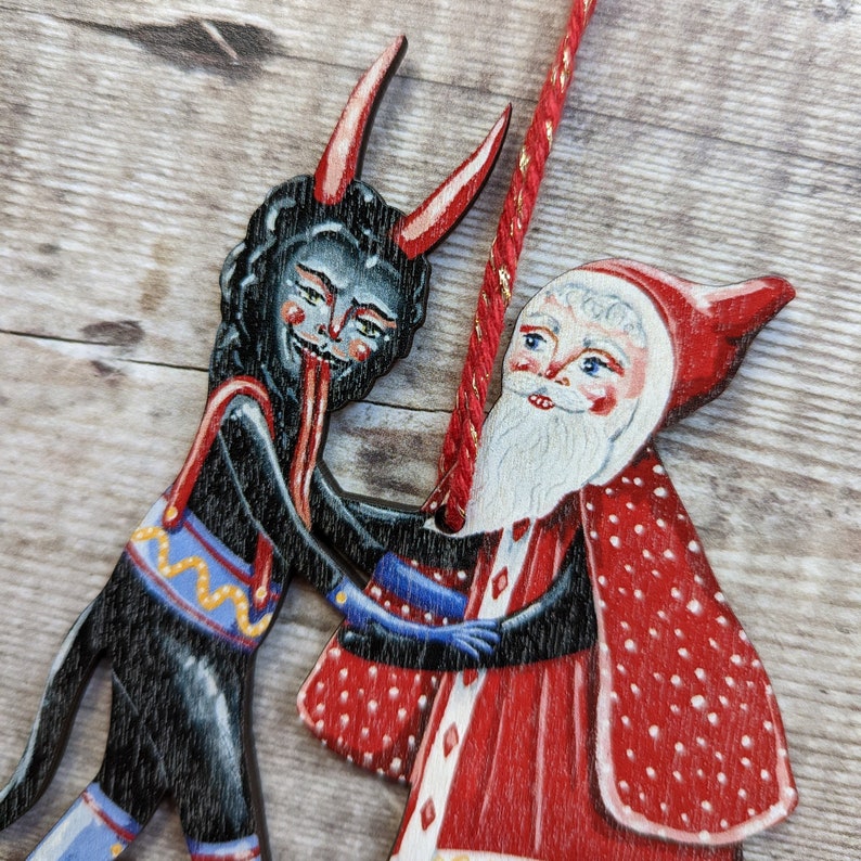 Wooden hanging Christmas ornament featuring Saint Nick dancing with the Christmas Krampus image 5