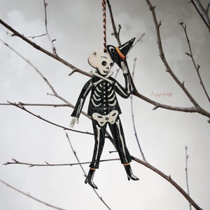 Wooden skeleton hanging ornament called "Bones". Self illustrated, made in the UK. Vintage style Halloween decor