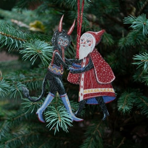 Wooden hanging Christmas ornament featuring Saint Nick dancing with the Christmas Krampus image 8