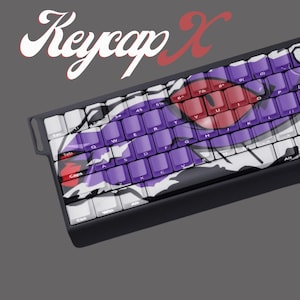 May include: A custom mechanical keyboard with purple, white, and red keycaps. The keycaps feature a unique design with a mix of colours and patterns. The keyboard has a black frame and the text "Keycap X" is displayed in the upper left corner.