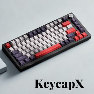 May include: A black mechanical keyboard with a variety of keycap colors, including white, red, and purple. The keyboard has a silver knob and the text "KeycapX" at the bottom.